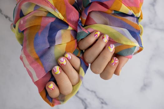 Woman manicured hands, stylish summer colorful nails. Closeup of manicured nails of female hand. Summer style of nail design concept. Beauty treatment.