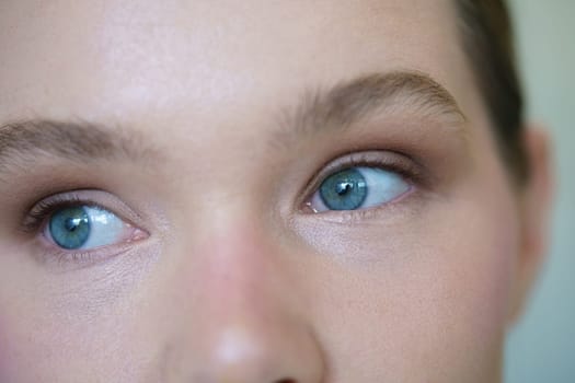 Close-up of the blue eyes of a blonde woman indoors