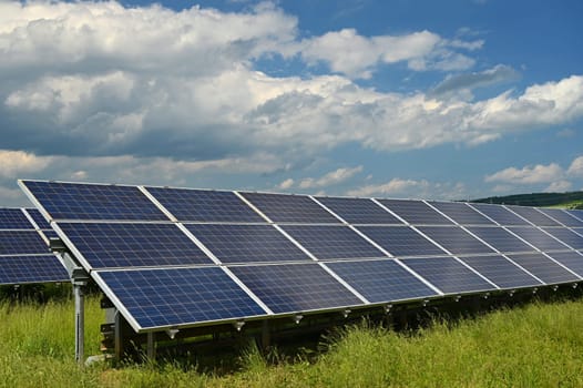 Solar power plant - concept for electricity and ecological industry. High energy prices. Beautiful landscape and sunny day with blue sky. Photovoltaic power plant.