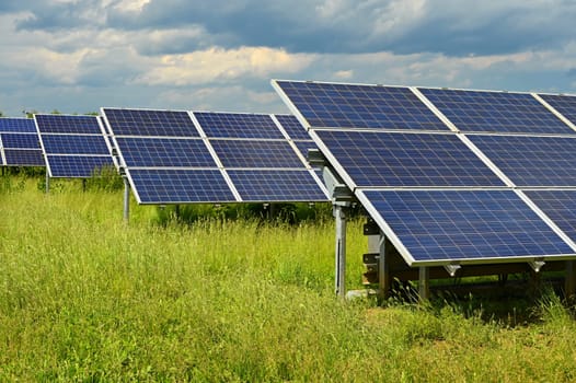 Solar power plant - concept for electricity and ecological industry. High energy prices. Beautiful landscape and sunny day with blue sky. Photovoltaic power plant.