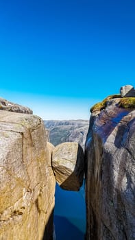 Kjeragbolten, Norway A large boulder precariously perched between two cliffs at the Pulpit Rock in Norway.