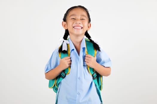 Portrait smiling Asian little girl kindergarten with schoolbag studio shot isolated white background, good job feedback, happy woman kid in pigtails wearing school uniform, back to school concept