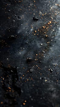 A macro photograph of a dark surface covered in glistening gold specks, resembling a miniature galaxy. It captures the beauty of cosmic elements in a mesmerizing way