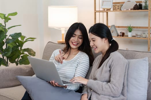 pride month Happy woman lesbian gay lgbt couple using laptop to video call with family, friends. LGBTQ couple concept.