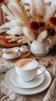 A cappuccino coffee cup with foam on a table, beverage drink in a breakfast setting with decoration