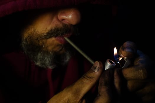 salvador, bahia, brazil - october 10, 2022: Crock user smoking the drug with a metal pipe in Salvador city.