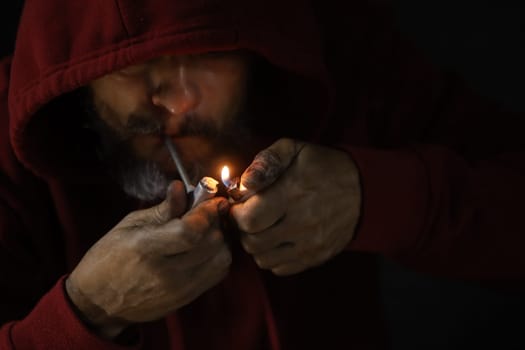 salvador, bahia, brazil - october 10, 2022: Crock user smoking the drug with a metal pipe in Salvador city.