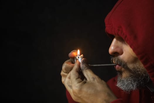 salvador, bahia, brazil - october 10, 2022: Crock user smoking the drug with a metal pipe in Salvador city.