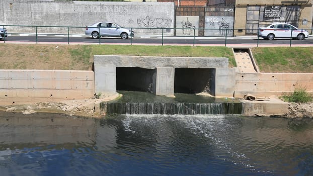 lauro de freitas, bahia, brazil - january 10, 2024: path of a pipeline with sewage water pouring into the Ipitanga River in the city of Lauro de Freitas.