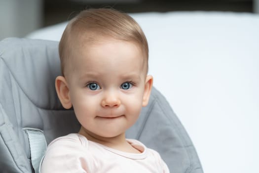 Close-up of an infant baby gazing at the camera with wide-eyed wonder