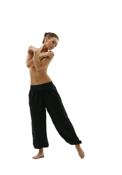 Full length photo of topless young woman posing in wide trousers
