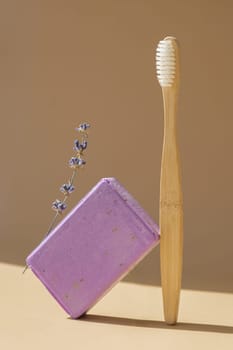 Eco friendly bamboo toothbrush and Handmade aromatic spa lavender soap. Natural additives and extracts. Bar of lavender soap with dried flowers. Beauty treatment product herbal ecological organic cosmetics. Copy space