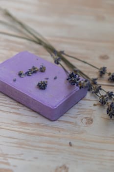 Handcrafted purple lavender soap with lavender flowers. Natural hydrating moisturiser softness cosmetic. Organic calming beauty skincare product. Herbal self care wellness alternative soap. Copy space