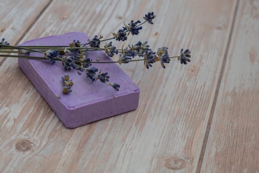 Lavender soap on wooden background with copy space for your text. Advertisement template mock up. Skincare homemade natural cosmetic concept. Organic dry lavender flower. Handmade soap