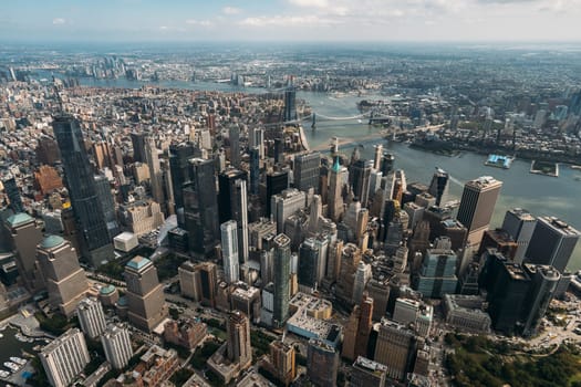 Stunning aerial view of the iconic New York City skyline showcasing its skyscrapers and the surrounding rivers. Expansive cityscape captures essence of a bustling metropolis with dynamic architecture