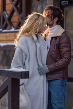 young couple hugging near the door outdoors