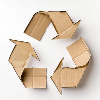 Cardboard recycle symbol made cardboard isolated on white background.