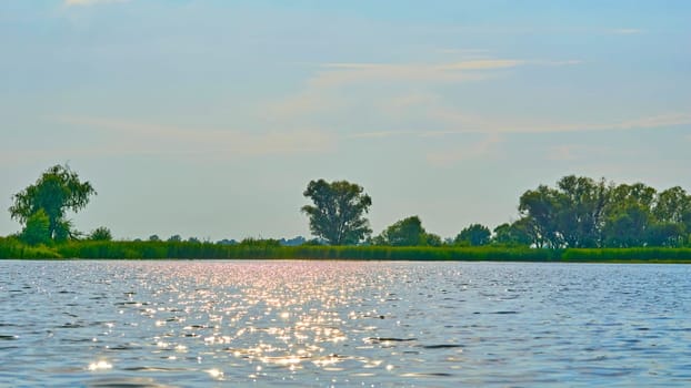 a large natural stream of water flowing in a channel to the sea, a lake, or another such stream