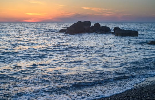 A stone in a calm sea at sunset 2