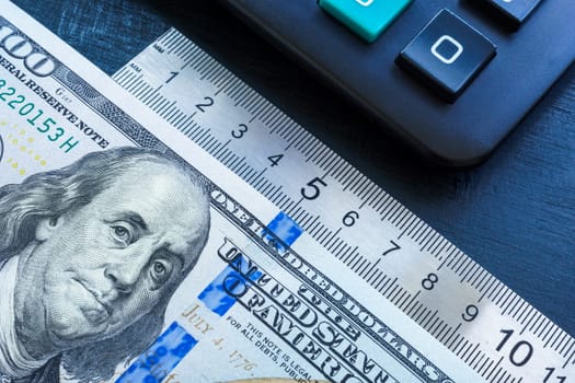 Money, ruler and a calculator. Performance based pay concept.