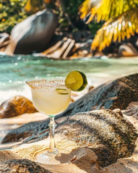 Tropical beach cocktail, margarita with lime on sandy shore, vacation concept.