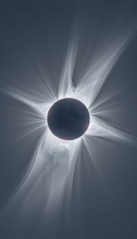 Total solar eclipse with visible corona, showcasing a dark silhouette of the moon against the sun, a celestial event.