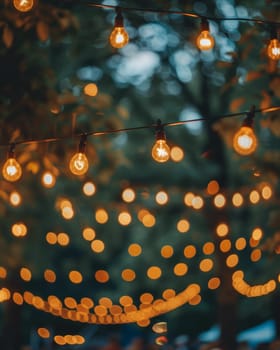 Illuminated string of light bulbs against a twilight backdrop, creating a warm, cozy, and romantic ambiance.