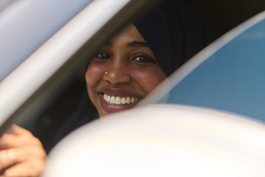 A Middle Eastern teenage girl enjoys a drive through scenic nature, embracing the freedom and beauty of the outdoors.