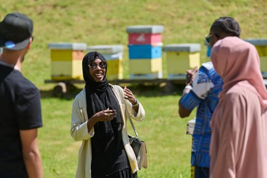 A diverse group of young friends and entrepreneurs explore small honey production businesses in the natural setting of the countryside