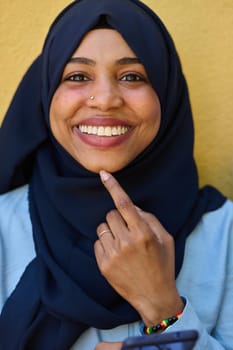 A close-up portrait captures the engagement of a Middle Eastern teenage Muslim girl in her digital world, as she uses a smartphone with focused attention