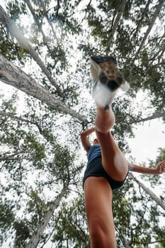 A brave woman traverses through the forest, fearlessly leaping over dangerous obstacles with determination and agility, showcasing her adventurous spirit and athletic prowess.