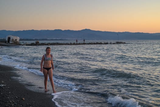 girl walking on the beach at sunset in Cyprus 1