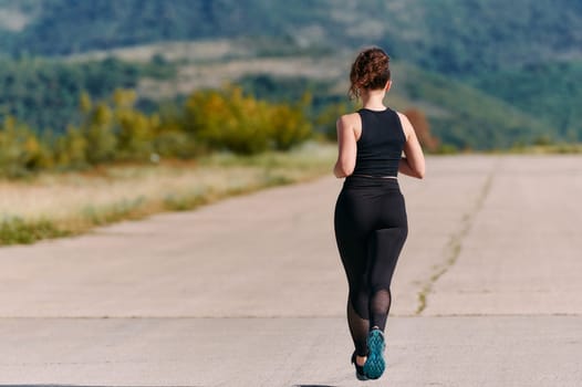 Rain or shine, a dedicated woman powers through her training run, her eyes set on the finish line.