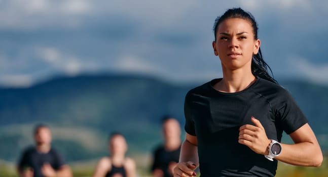 The leader leads a group of athletes on a sunny day run, inspiring and guiding them towards their fitness goals with determination and unity