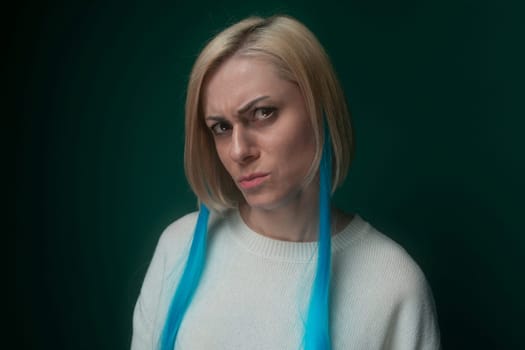 A woman is shown wearing a blue tie around her neck, the tie neatly knotted and adding a formal touch to her attire. She is looking directly at the camera, exuding confidence and professionalism.