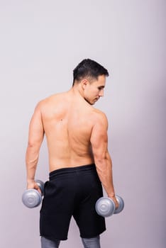 Shirtless bodybuilder showing his great body and holding dumbells.