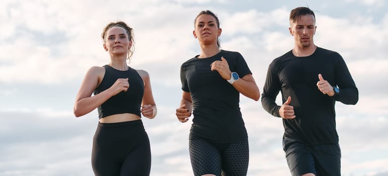 A professional athletic team as they train rigorously, running towards peak performance in preparation for an upcoming marathon.