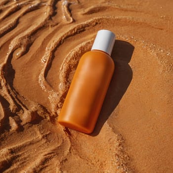 Orange bottle of cream without inscriptions. High quality photo. Sunscreen. Summer cream. Tanning product. Tanning remedy.