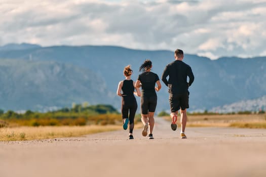 A professional athletic team as they train rigorously, running towards peak performance in preparation for an upcoming marathon.