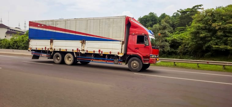 truck one of transportation mode making local commercial delivery at urban city and on the city streets in asia logistical transport system in Asian country Indonesia