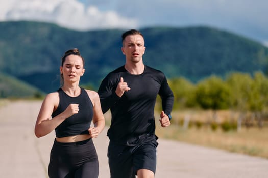 A couple embraces a healthy lifestyle by running together on a sunny day, exemplifying dedication to fitness and wellness in their partnership