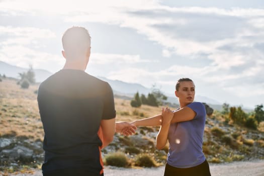 A couple engages in post-run stretching, fostering flexibility and recovery after an intense morning jog, promoting health and well-being in their fitness routine