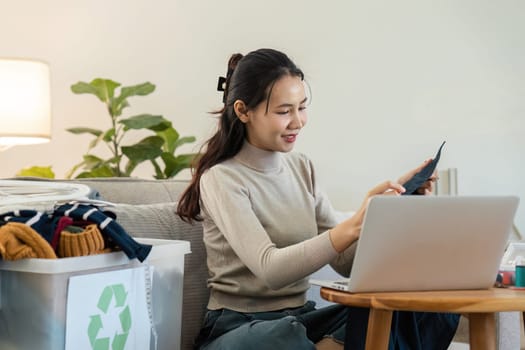 A young woman sorts recyclable materials at home, promoting an eco-friendly lifestyle and sustainable living practices.