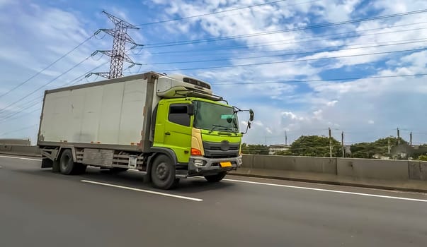 truck one of transportation mode making local commercial delivery at urban city and on the city streets in asia logistical transport system in Asian country Indonesia