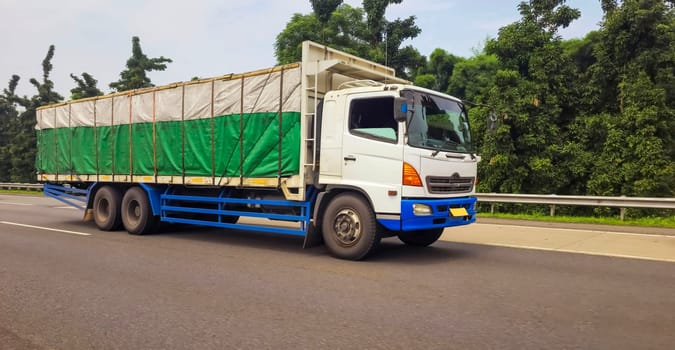 truck one of transportation mode making local commercial delivery at urban city and on the city streets in asia logistical transport system in Asian country Indonesia