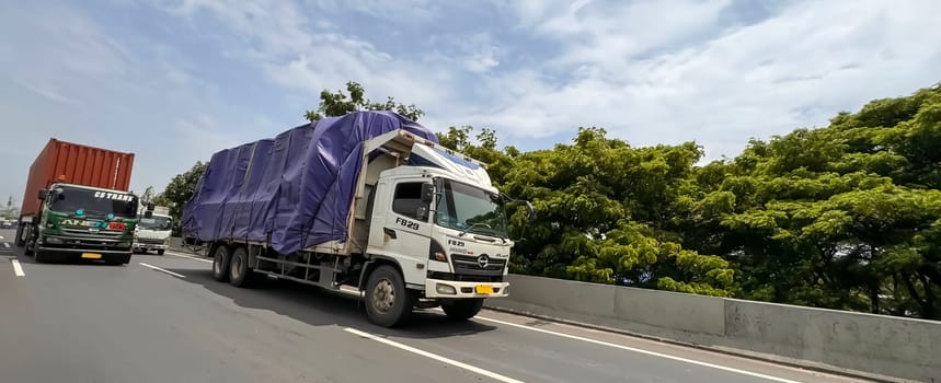 truck one of transportation mode making local commercial delivery at urban city and on the city streets in asia logistical transport system in Asian country Indonesia