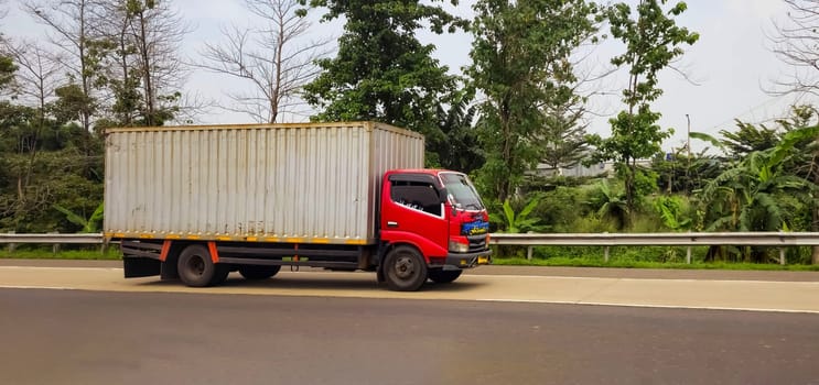 truck one of transportation mode making local commercial delivery at urban city and on the city streets in asia logistical transport system in Asian country Indonesia