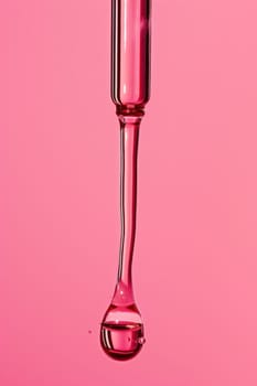 Pink liquid dripping from test tube on pink background for medical experiment and research concept