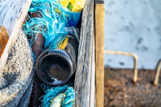 Bottle of beer bottle peeking out of storage box.