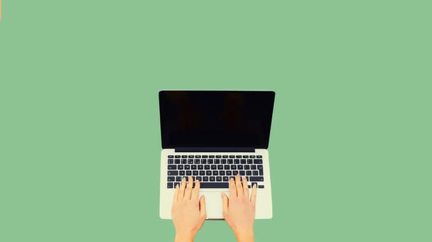 Close up female hands woman working with laptop and blank black screen on green background